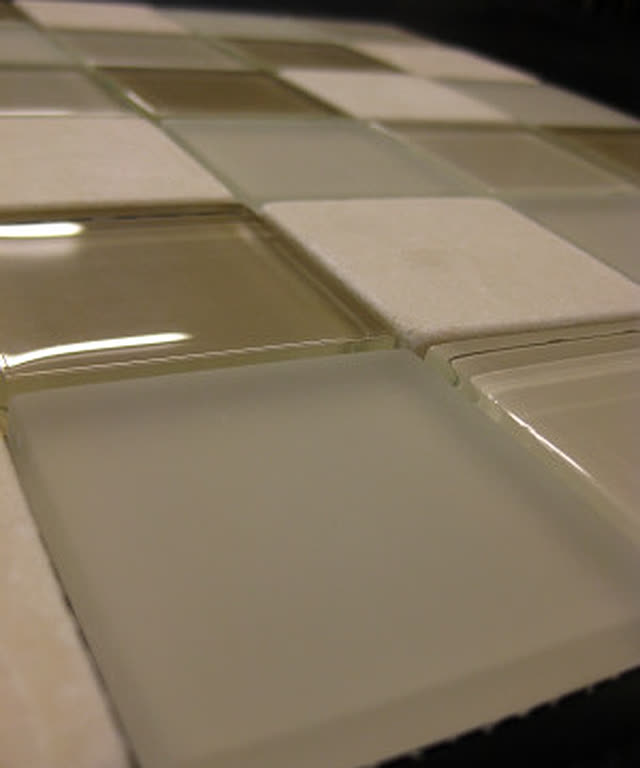 Glossy cream glazed ceramic field tile, close up.