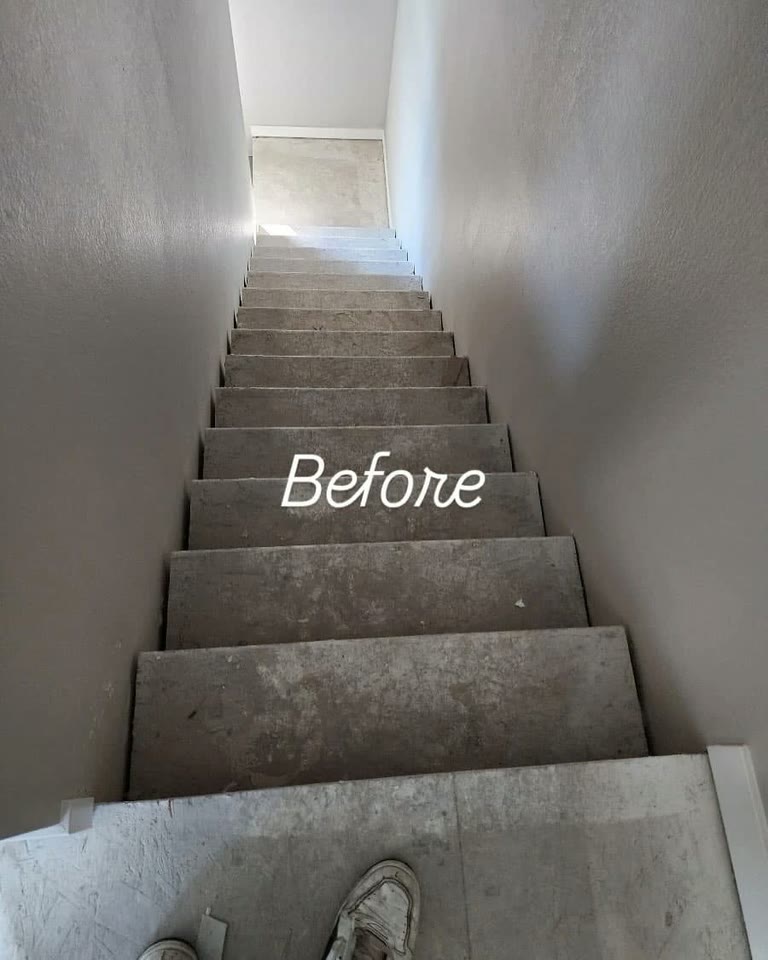 The stairway before the work, the treads bare and dusty.